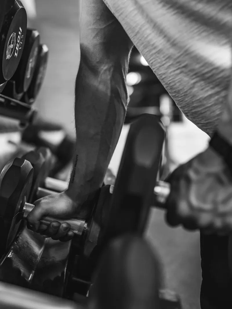 Client using advanced strength training exercises at Forge Athletics in Naples, FL