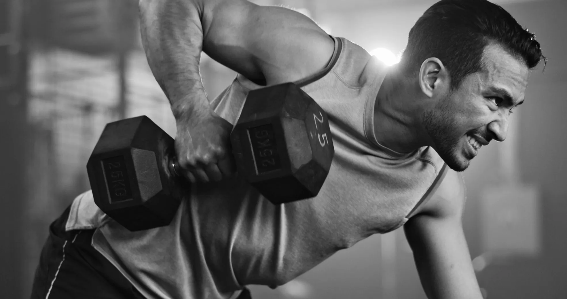 Man performing weightlifting and building back and core strength at Forge Athletics in Naples, FL