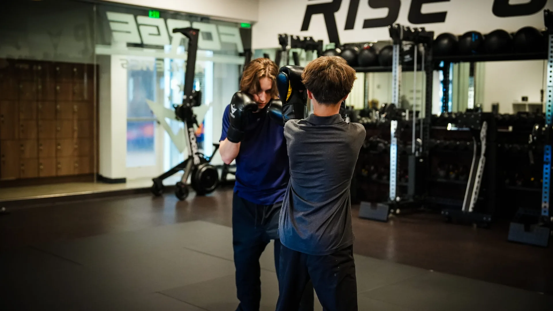 Kid training with a coach at Forge Athletics MMA program in Naples FL