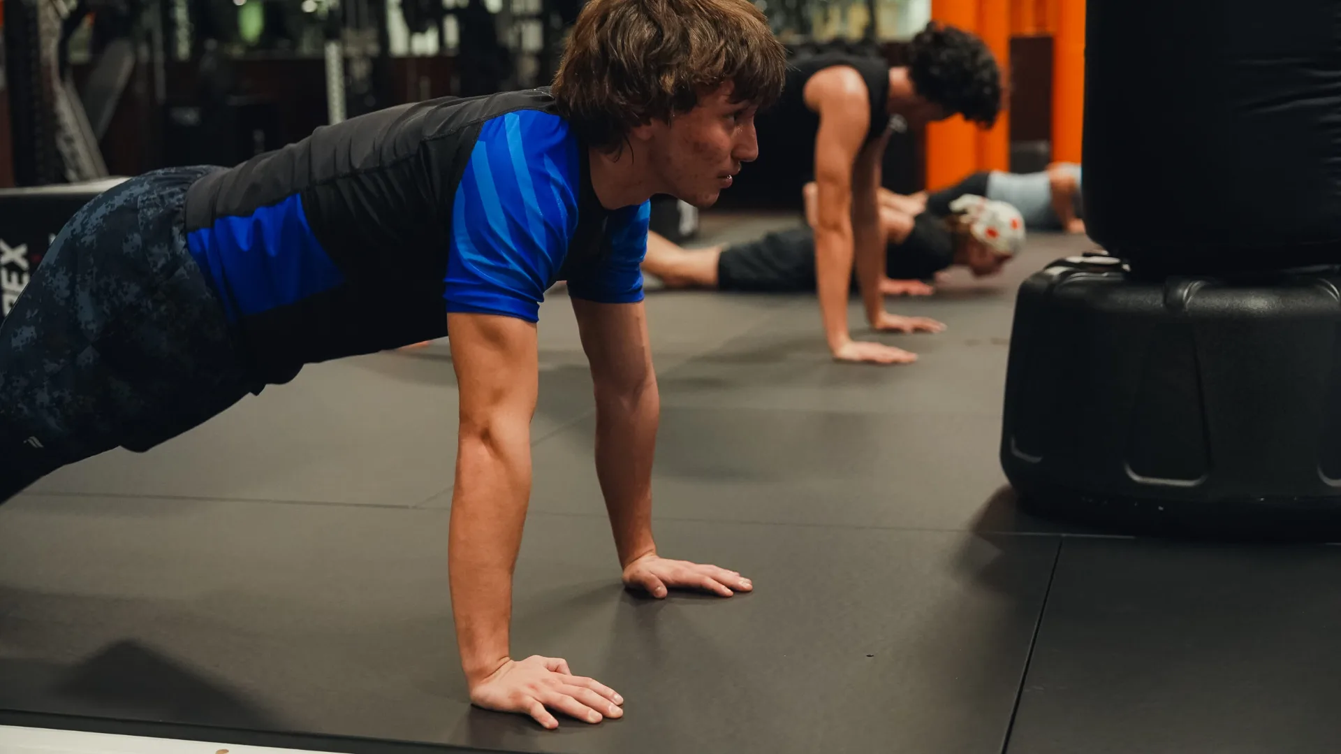 Forge Athletics client doing plank and core work with a Naples personal trainer as part of fitness goal coaching