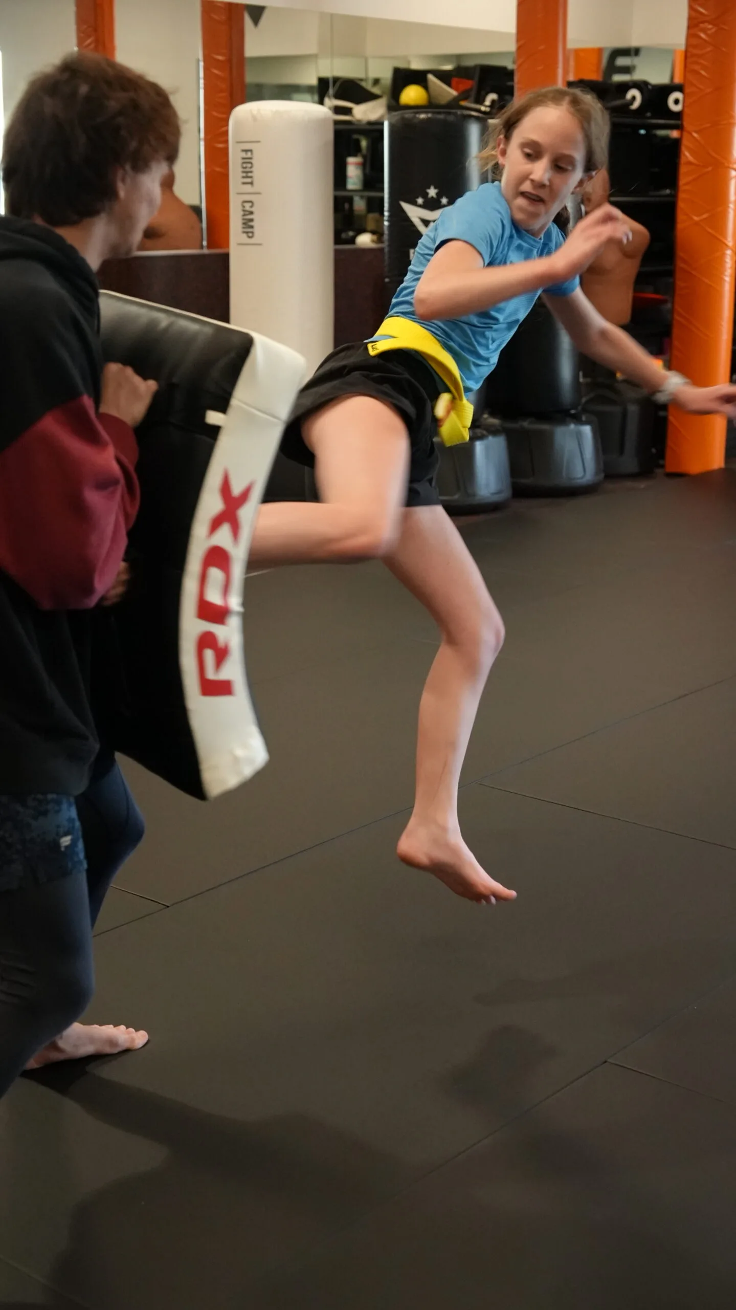 Teen student throwing a high kick at Forge Athletics martial arts summer camp in Naples FL